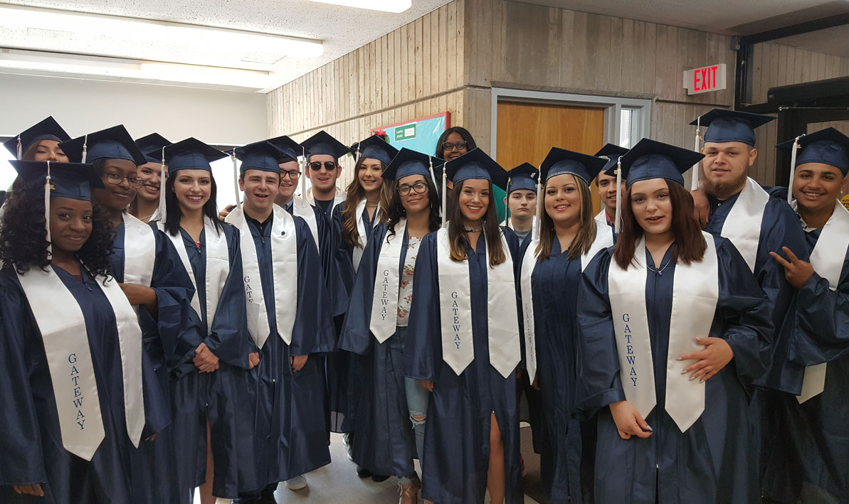 Gateway to College graduates wearing caps and gowns prior to 2018 graduation